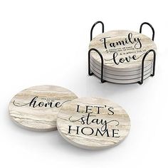 three coasters with the words family love and home written in black ink on them