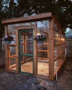 a small wooden structure with plants in it