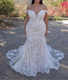 a woman in a wedding dress posing for the camera