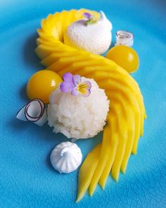 some food is laying out on a blue plate with white and yellow stuff around it