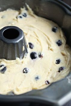 a cake pan filled with batter and blueberries
