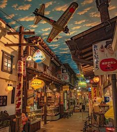 an airplane painted on the ceiling of a shopping area in japan with people walking around