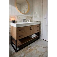 a bathroom with marble flooring and white walls is pictured in this image, there is a round mirror on the wall above the sink