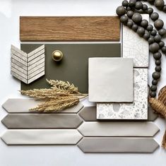 a white table topped with lots of different types of tile and wood pieces on top of each other