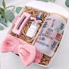 a pink bow tie sitting next to a bottle of perfume in a box with the number 1 on it