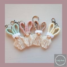 four keychains with tassels on them sitting next to eachother