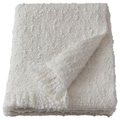 a white blanket with fringes on it
