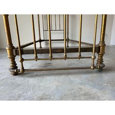 an antique brass bed frame and foot board with turned down posts on the bottom part