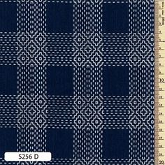 a blue and white checkered fabric with a ruler in front of the image, it is