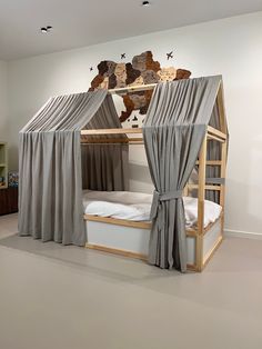 a bunk bed with curtains on the top and bottom