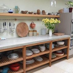 a kitchen with lots of pots and pans on the counter top next to an oven