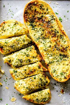 slices of garlic bread on a baking sheet