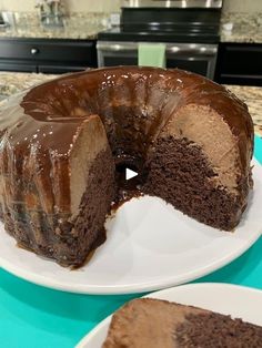 a chocolate cake on a plate with one slice missing