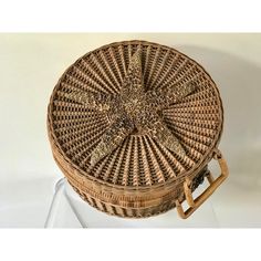 a wicker basket sitting on top of a white table next to a brown bag