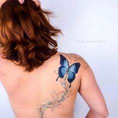 a woman with a blue butterfly tattoo on her upper back and right side of her body