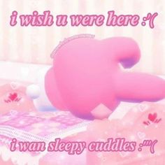 a pink teddy bear laying on top of a bed