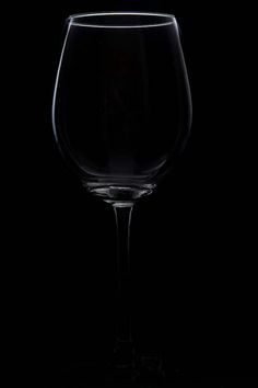 an empty wine glass on a black background