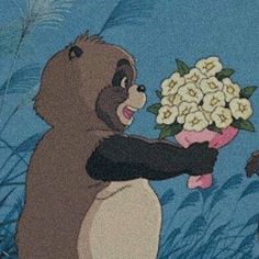 the bear is holding flowers in his hand