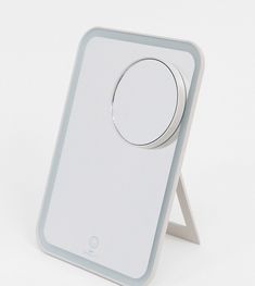 an electronic device is shown on a white surface with a circular object in the middle