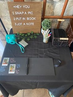 a table with a sign that says, hey you snap a pic put in book and not a note
