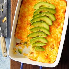 a casserole dish with sliced avocados on top