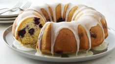 a bundt cake with white icing on a plate