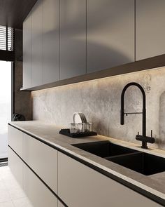 a kitchen with white cabinets and black faucets on the counter top, along with a sink