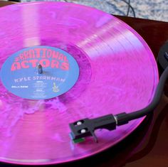 a pink record player with the words traditional actors on it