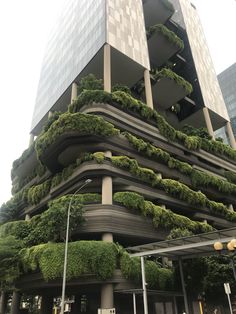 a very tall building with lots of plants growing on it