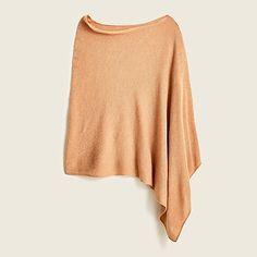 a tan sweater hanging on a white wall