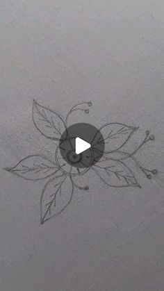 an image of a flower drawn on the surface of a sheet of paper with a video play button