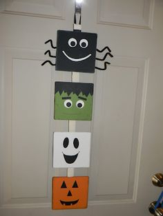 a door hanger decorated to look like halloween decorations