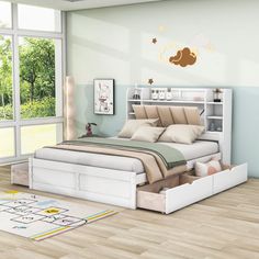 a white bed sitting in a bedroom on top of a hard wood floor next to a window