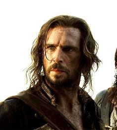two people standing next to each other with long hair and beards on their heads