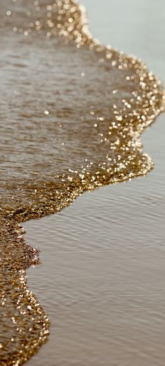 the beach is covered in golden sand and water