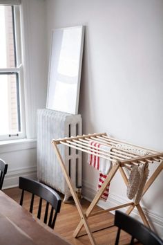 an ironing board on a wooden table next to a radiator