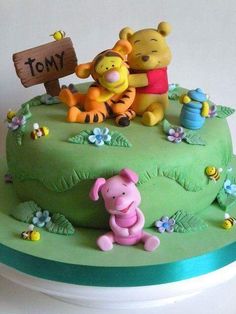 a winnie the pooh birthday cake is decorated with fondant