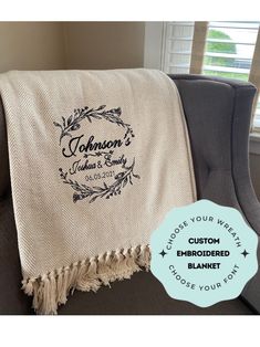 the personalized throw blanket is sitting on a chair with a blue ribbon around it