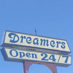 a sign for a restaurant that says dreamers open 24 / 7 on the front