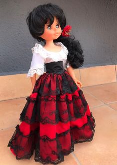 a doll wearing a red and black dress