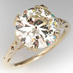 This stunning vintage diamond ring is accented with one (1) round brilliant cut diamond weighing 4.02 carats that is set into a four-prong setting. The shoulders and head feature a pierced design. The ring measures 11.0mm at the top, rises 7.8mm above the finger, tapering to 1.3mm wide and 1.8mm thick at the base of the shank. The ring is currently a size 6.5. Huge Diamond Rings, Beads Bangles, Antique Diamond Engagement Rings, Ring Inspiration, Statement Rings Diamond, Pretty Ring, Vintage Diamond Rings, Art Deco Engagement, Dream Engagement