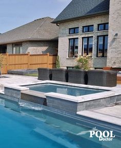 an empty swimming pool in front of a house