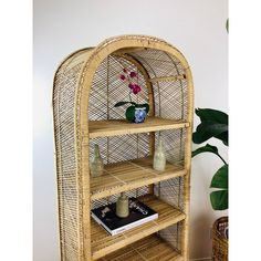 a wicker book shelf with flowers on top