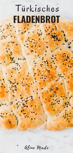 a close up of a bread with poppy seed sprinkles on the top