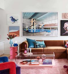 a living room filled with furniture and pictures on the wall above it's coffee table