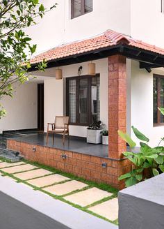 a small white house with a red tiled roof