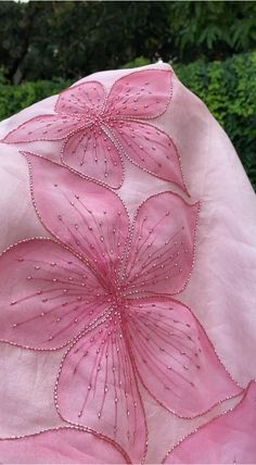 a pink hat with flowers on it