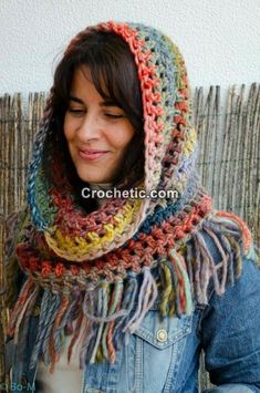 a woman wearing a multicolored crocheted scarf