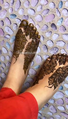 the legs and feet of a woman with henna tattoos