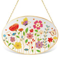 a white and yellow flowered purse hanging from a gold - plated metal chain